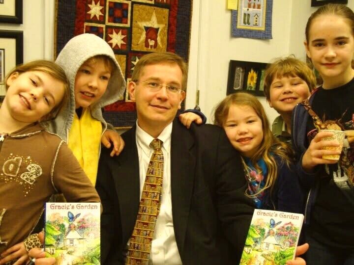 Jamie Mock with his children at a Gracie's Garden book signing